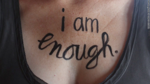 brene brown photo showing I am Enough written on a woman's chest